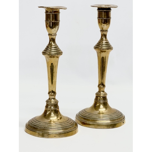 140 - A pair of Victorian brass candlesticks. 11.5x26.5cm