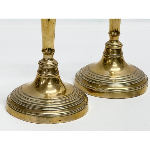 140 - A pair of Victorian brass candlesticks. 11.5x26.5cm