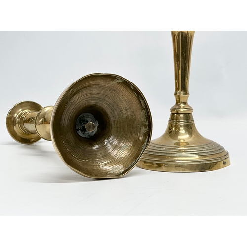 140 - A pair of Victorian brass candlesticks. 11.5x26.5cm