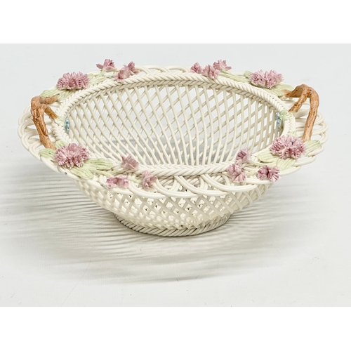 141 - A Belleek Millennium 2000 ‘Wedding Bouquet’ woven basket. 21x21x9cm