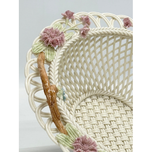 141 - A Belleek Millennium 2000 ‘Wedding Bouquet’ woven basket. 21x21x9cm