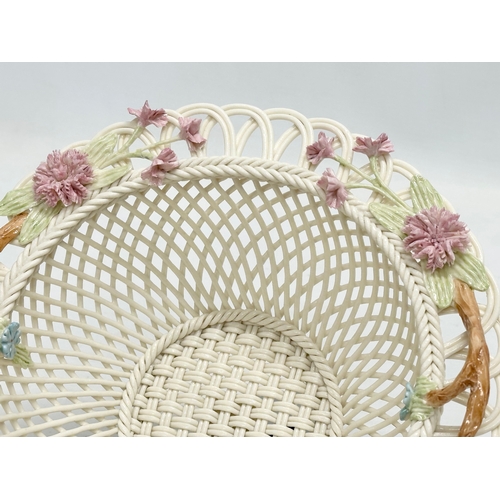 141 - A Belleek Millennium 2000 ‘Wedding Bouquet’ woven basket. 21x21x9cm