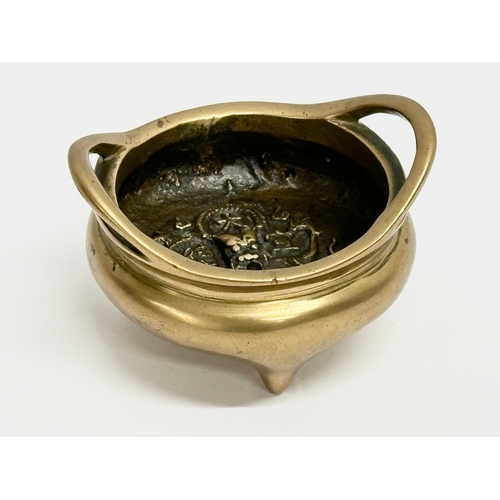 17 - An 18th/19th Century Chinese brass tripod censer with impressed interior dragon motif. Impressed Emp... 