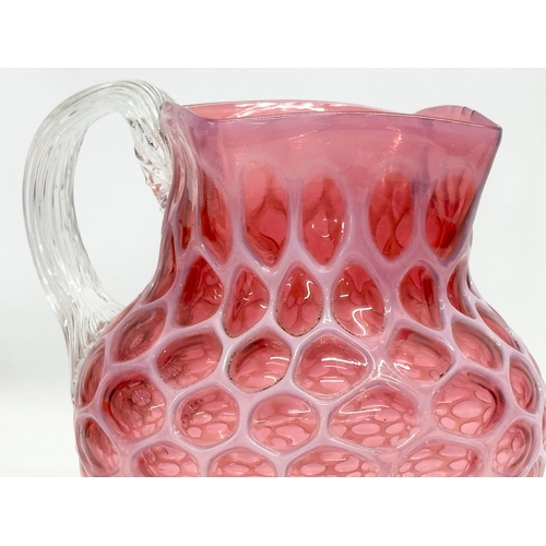 101 - A large 19th Century Victorian opalescent cranberry glass pitcher. 17x21x20cm