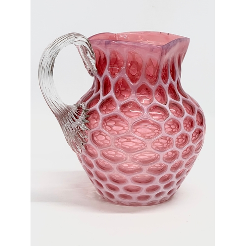 101 - A large 19th Century Victorian opalescent cranberry glass pitcher. 17x21x20cm