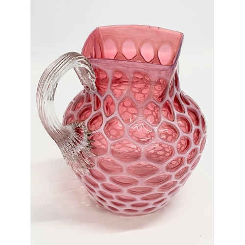 101 - A large 19th Century Victorian opalescent cranberry glass pitcher. 17x21x20cm