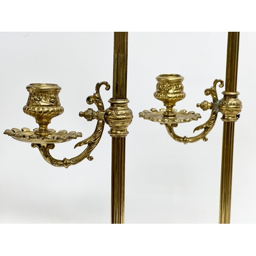 22 - A pair of large Late 19th Century Victorian brass rise and fall candlesticks. 43cm.