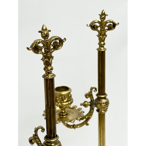 22 - A pair of large Late 19th Century Victorian brass rise and fall candlesticks. 43cm.