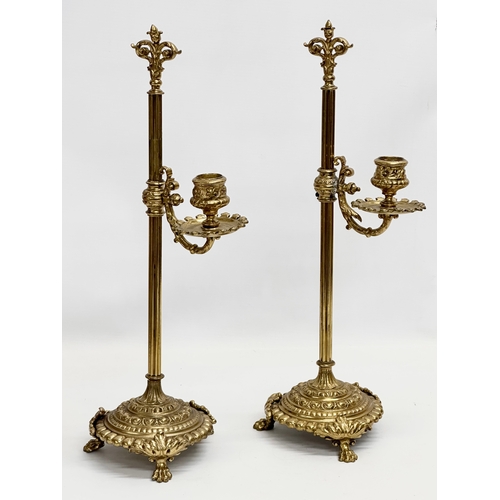 22 - A pair of large Late 19th Century Victorian brass rise and fall candlesticks. 43cm.