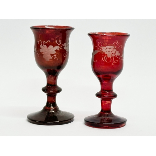 106 - Three 19th Century Bohemian ruby cordial glasses. 9.5cm. 7cm.