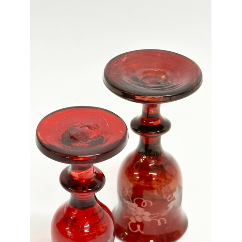 106 - Three 19th Century Bohemian ruby cordial glasses. 9.5cm. 7cm.