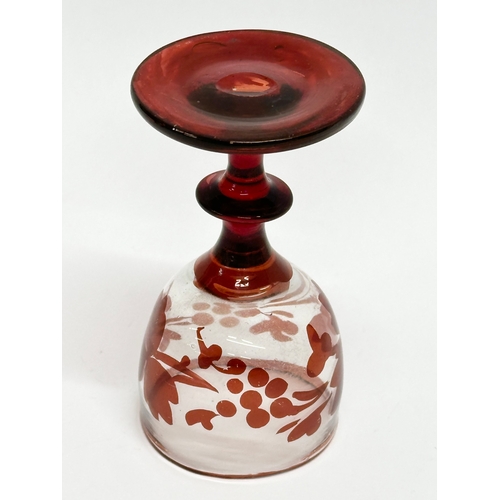 106 - Three 19th Century Bohemian ruby cordial glasses. 9.5cm. 7cm.