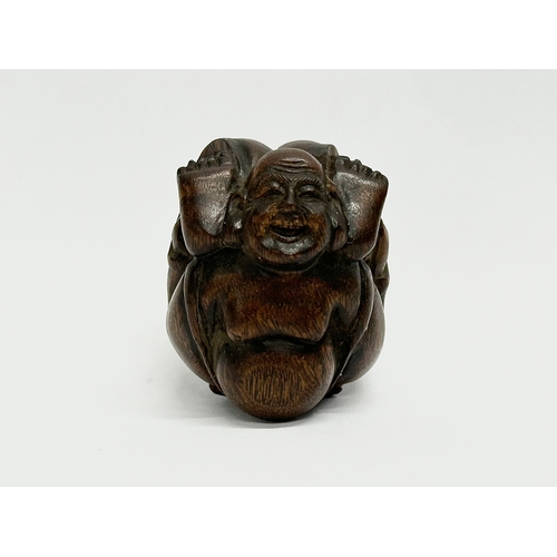 34 - A signed Late 19th/Early 20th Century Netsuke carved wooden Buddha.