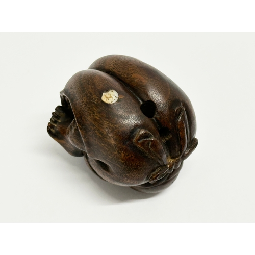 34 - A signed Late 19th/Early 20th Century Netsuke carved wooden Buddha.