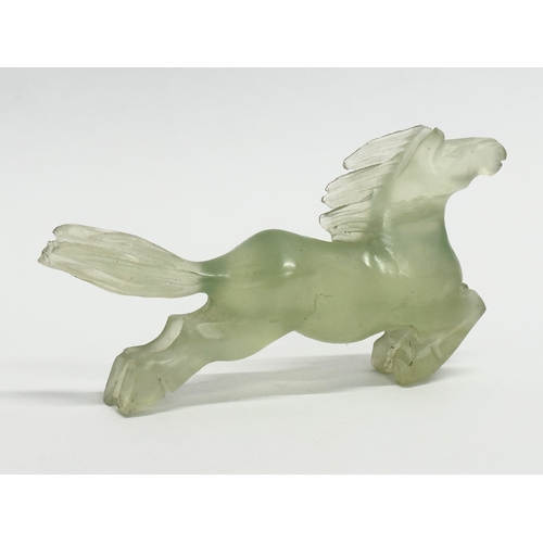 151 - A Chinese green jade horse sculpture. 9cm