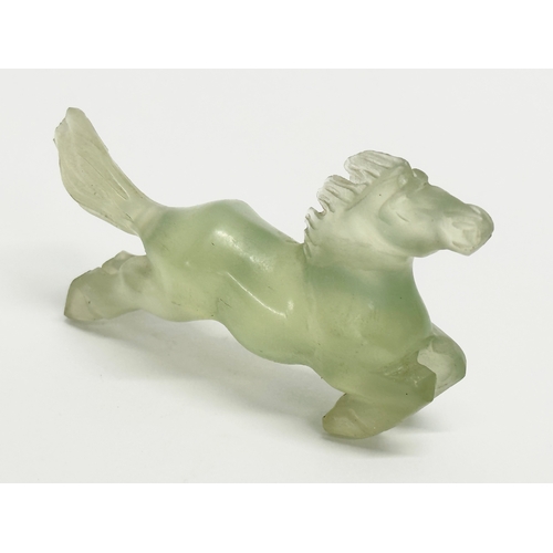 151 - A Chinese green jade horse sculpture. 9cm