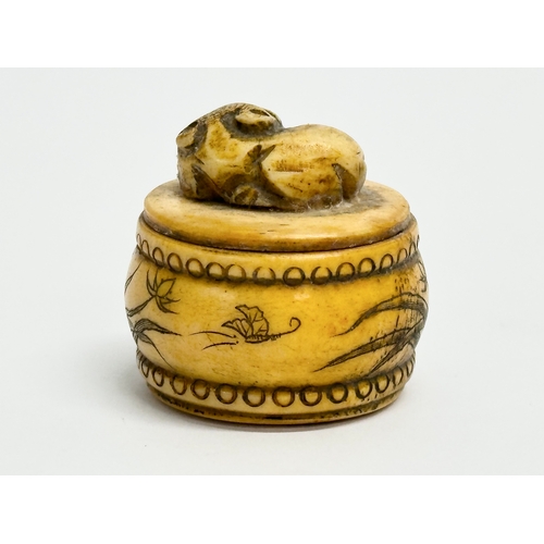 152 - A signed Chinese style carved bone pill box. Signed T Schultz.