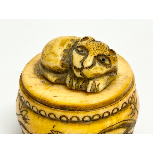 152 - A signed Chinese style carved bone pill box. Signed T Schultz.