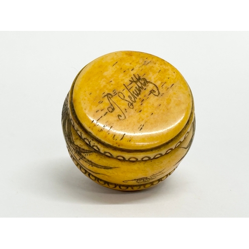 152 - A signed Chinese style carved bone pill box. Signed T Schultz.