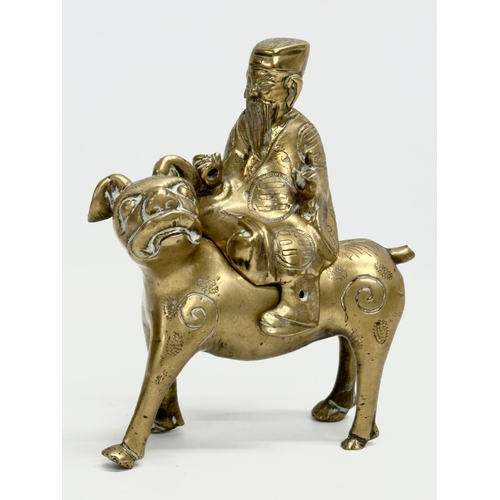 108 - A pair of Late 19th/Early 20th Century Chinese brass Foo Dogs and riders. 15x19cm.