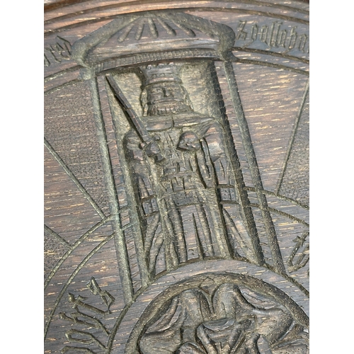 128 - A Late 19th Century King Arthur carved oak table plaque. The Knights of the Round Table. 33.5cm