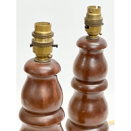 120 - A pair of Mid Century teak table lamps. 32cm