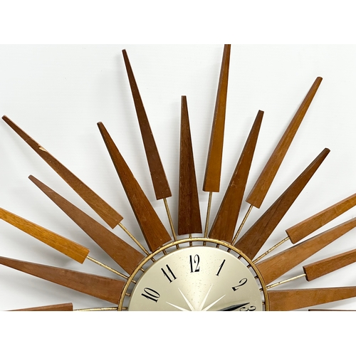 115 - A 1960’s Seth Thomas Mid Century teak sunburst clock. 66cm