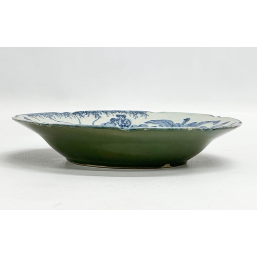 198 - A Chinese blue and white bowl with celadon glazed base. Seal mark. 19.5x4cm