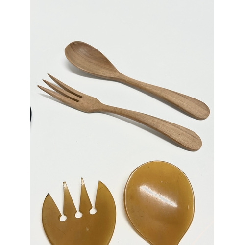 117A - A pair of Danish Mid Century teak food servers with others.