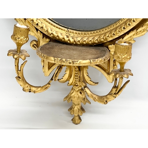 14 - An Early 19th Century Regency gilt framed Girandole mirror. Circa 1810. 49x94cm