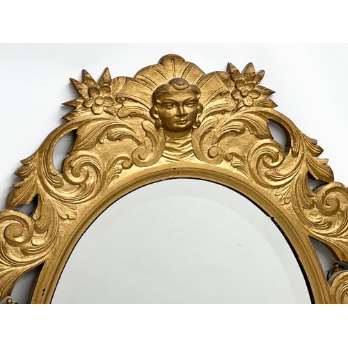 244 - An Early 20th Century gilt wooden framed bevelled mirror. 65x91cm.