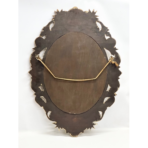 244 - An Early 20th Century gilt wooden framed bevelled mirror. 65x91cm.