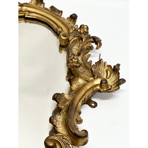 230 - A 19th Century Victorian gilt framed Rococo style mirror. 58x83cm