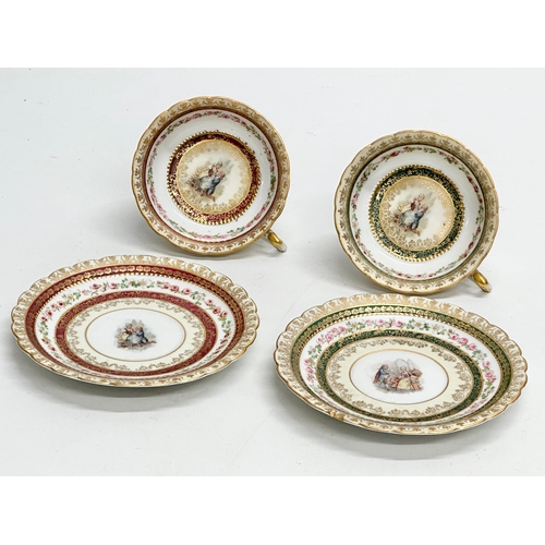 253 - A pair of Early 20th Century Rococo hand painted cups and saucers.