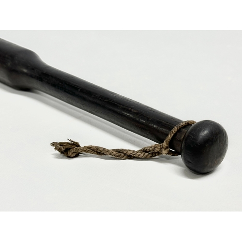 258 - A 19th Century ebony police truncheon. 28cm