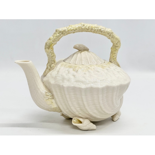 259 - A 5th Period Belleek Pottery ‘Tridacna’ 3 piece tea service. A teapot, sugar bowl and creamer. Circa... 