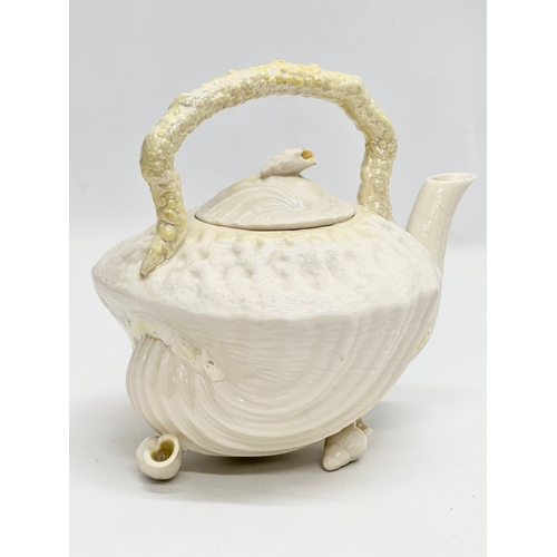 259 - A 5th Period Belleek Pottery ‘Tridacna’ 3 piece tea service. A teapot, sugar bowl and creamer. Circa... 