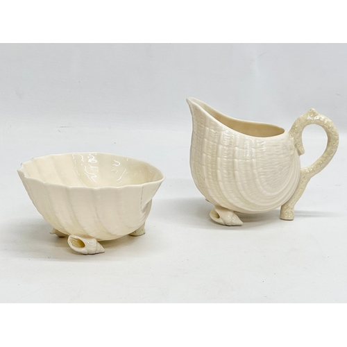 259 - A 5th Period Belleek Pottery ‘Tridacna’ 3 piece tea service. A teapot, sugar bowl and creamer. Circa... 