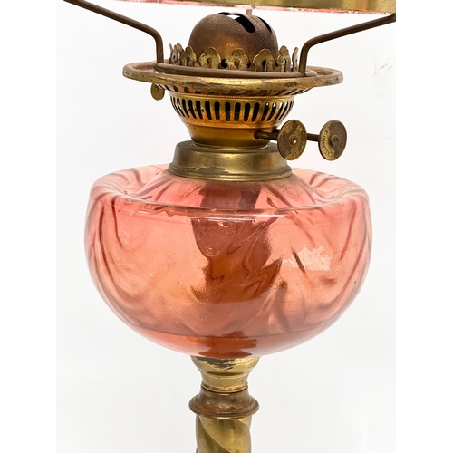 264 - A large Late 19th Century Victorian double burner oil lamp. With brass column and cranberry glass bo... 