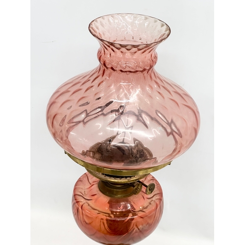 264 - A large Late 19th Century Victorian double burner oil lamp. With brass column and cranberry glass bo... 