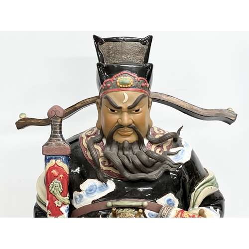 240A - Shiwan. A large Chinese Bao Zheng statue by Shiwan. Impressed mark. Late 20th Century. 28x61cm.