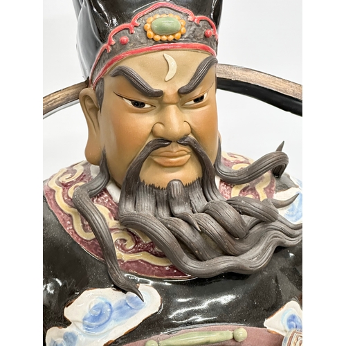 240A - Shiwan. A large Chinese Bao Zheng statue by Shiwan. Impressed mark. Late 20th Century. 28x61cm.