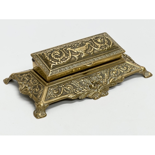 329 - 3 Late 19th and Early 20th Century brass desktop items. A brass desktop stamp holder. A Victorian Pe... 