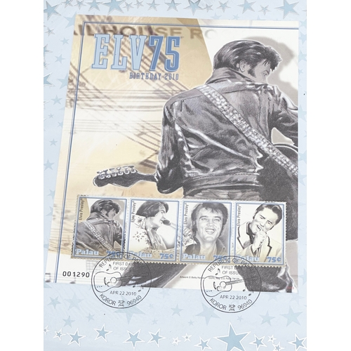 584 - A collection of Elvis Presley memorabilia. Including VHS tapes and stamps etc.