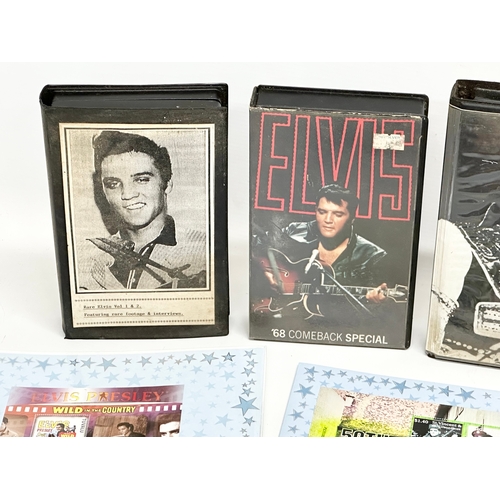 584 - A collection of Elvis Presley memorabilia. Including VHS tapes and stamps etc.