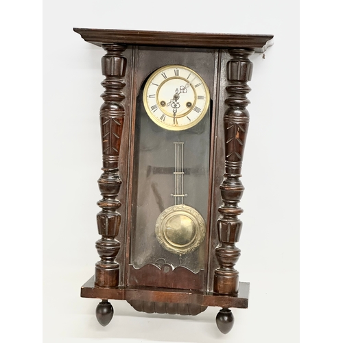 365 - A Late 19th Century Victorian mahogany Vienna wall clock. With key and pendulum. 42x64cm