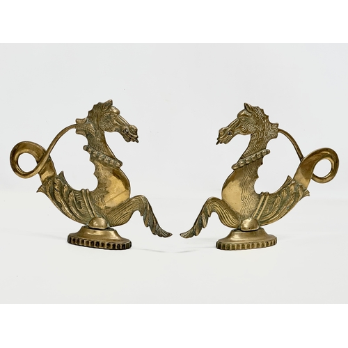 349 - A pair of Late 19th Century brass fireside seahorses. 28x23cm