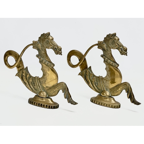 349 - A pair of Late 19th Century brass fireside seahorses. 28x23cm