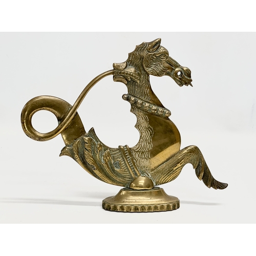 349 - A pair of Late 19th Century brass fireside seahorses. 28x23cm