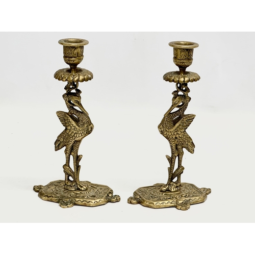 350 - A pair of Early 20th Century brass peacock candlesticks. 11x19cm